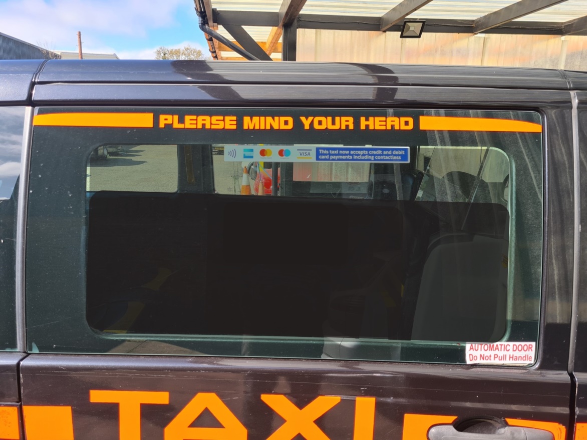 This taxi now accepts credit and debit card payments including contactless sign position