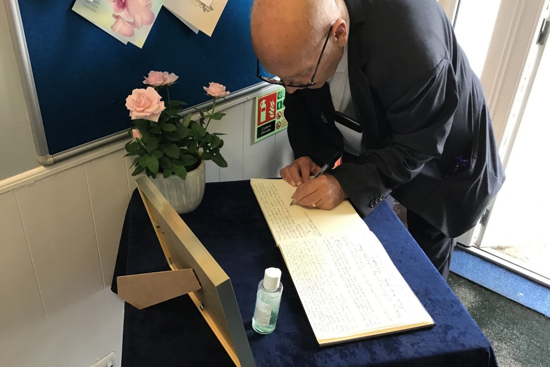Councillor Souter signing the book of condolence for Sir David Amess MP