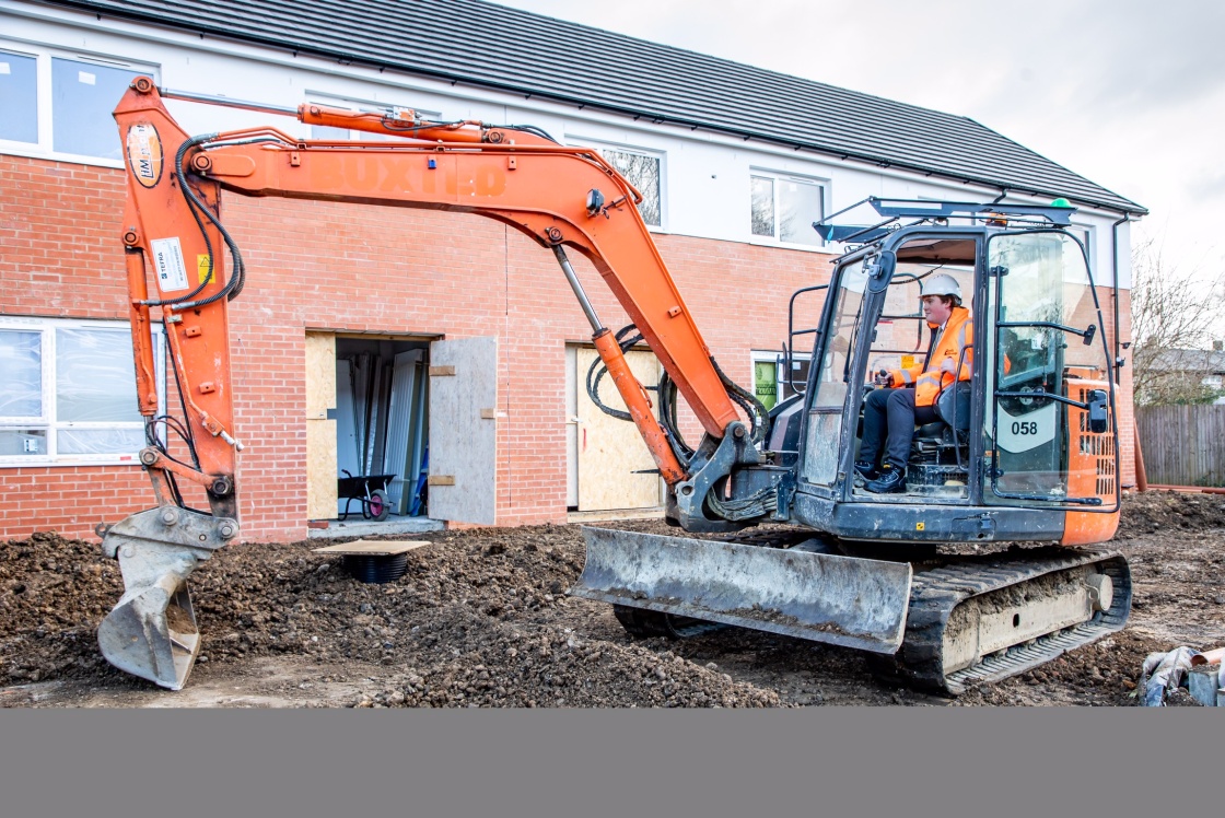 JCB on Bushey Croft council house building site Image of JCB on building site in Bushey Croft
