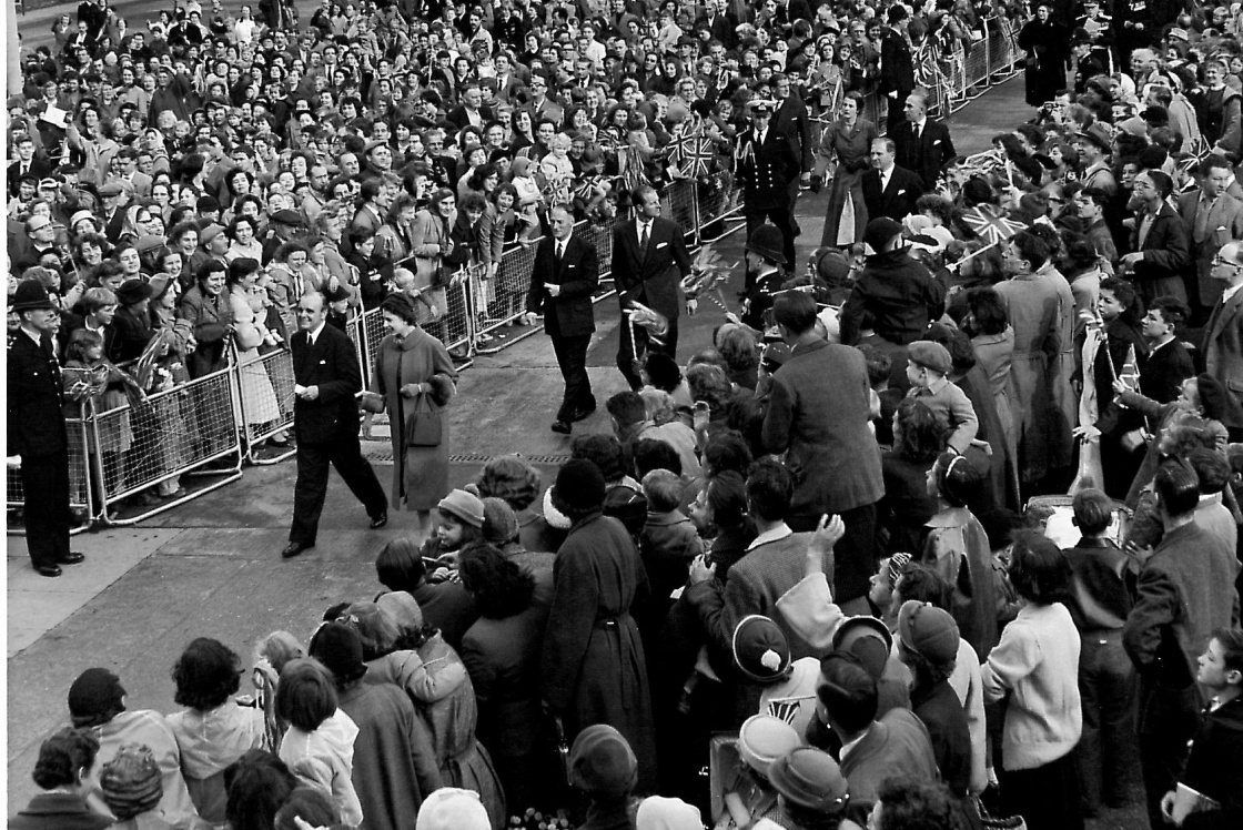The Queen and Prince Phillip walking through Stone Cross