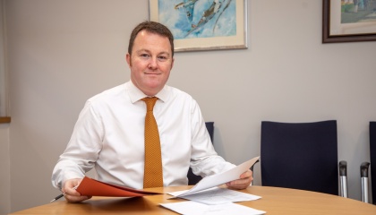 Image of Councillor Russell Perrin, Leader of the Council at his desk 