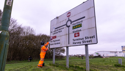 Image of large highway sign being cleaned 