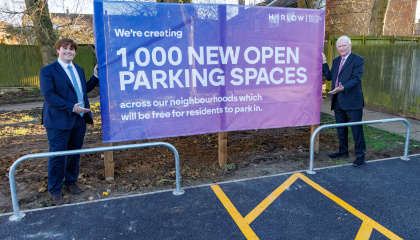 Image of Councillor Dan Swords and Councillor David Carter with a banner marking the 1,000 car parking spaces