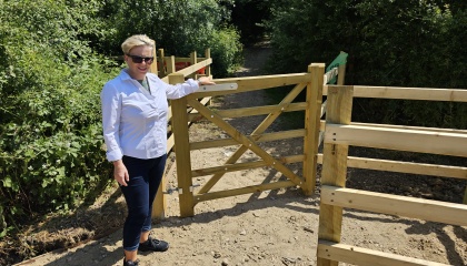 Councillor Nicky Purse standing next to a new kissing gate on Harlow Common