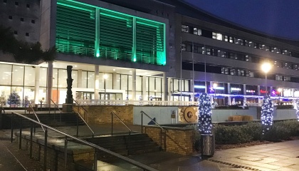 Image of the Civic Centre balcony lit up with green lights 