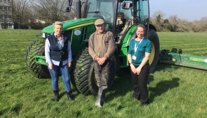 Image of Councillor Purse with HTS staff and grass cutting tractor 