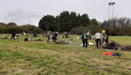 Image of volunteers planting new trees in the Community Orchard off Southern Way