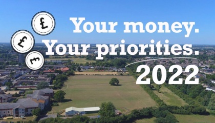 Aerial image of town with the words your money, your priorities 