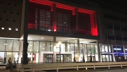 Image of the outside of Harlow Civic Centre balcony lit up in red