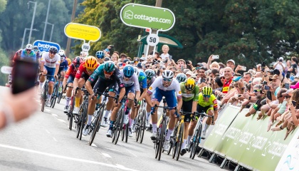 Image of cyclists from the Tour of Britain race approaching the finishing line on Third Avenue 