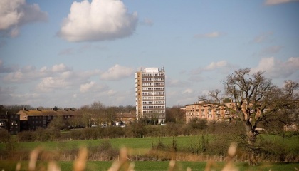Photo of green field with Pennymead Tower in the distance 