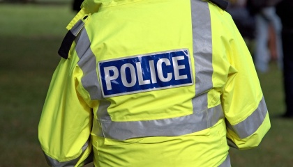 Image of back of Police officer’s uniform with the word Police 