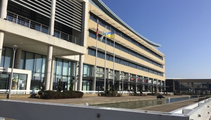 Image of outside of Harlow Civic Centre with flags flying 
