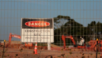 Image of construction site with sign saying: danger, construction site unauthorised persons keep out 