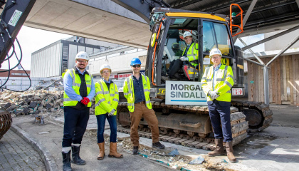 Image of councillors, staff and contractors with demolition vehicles on site for rebuild of bus station 