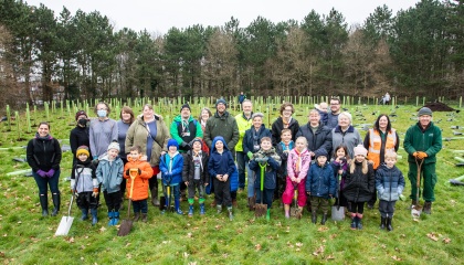 Image of councillors, staff, volunteers and residents at a tree planting event on the helipad site 