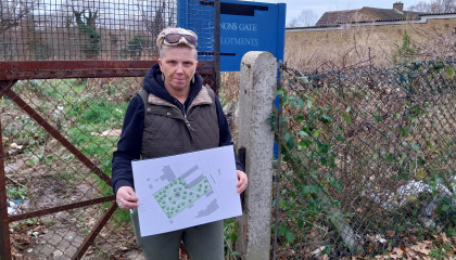 Image of Councillor Nicky Purse holding a copy of the Community Orchard plan