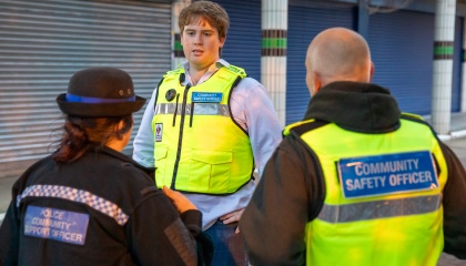 Councillor Dan Swords speaking to a police community support officer and one of the council's community safety officers at The Stow