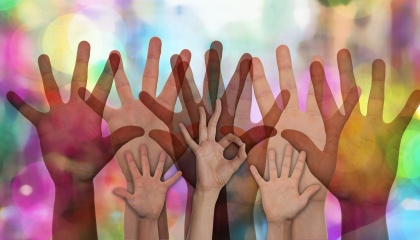 Image of different hands in the air to represent volunteering 