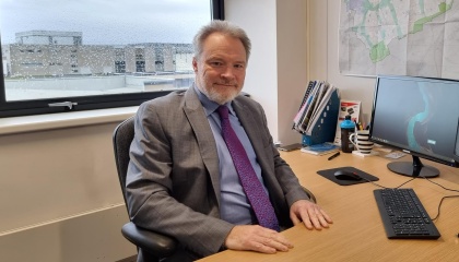 Image of Andrew Bramidge at his desk 
