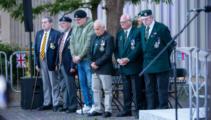 A group of veterans standing on stage at the D-Day event