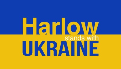 Image of Ukraine flag in half blue half yellow with the words Harlow stands with Ukraine