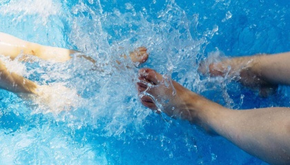 Feet splashing in water