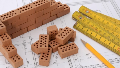 Bricks, tape measure, pencil and plans