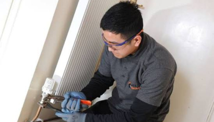 HTS staff member repairing a radiator